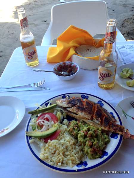 One of our favourite meals, fresh red schnapper, guacamole and Sol Beer on the beach at Zihuatanejo