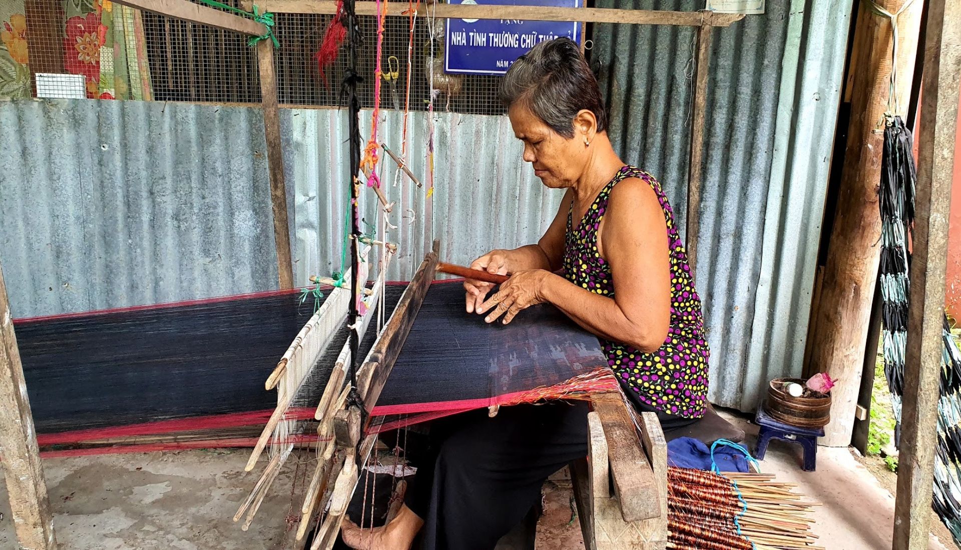 Khmer woman weaving traditional shawls